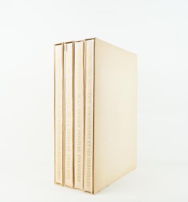 three books stacked on top of each other on a white surface