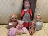 a lot of dolls that are sitting on a couch