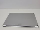 an apple laptop computer sitting on top of a white table