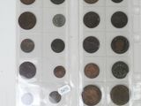 several different types of coins are displayed on a white surface