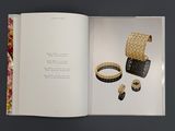 an open book with a picture of a bunch of jewelry on it