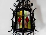 wrought iron hanging light fixture with stained glass panels