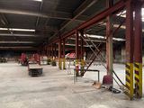 a large warehouse with a lot of tables and chairs in it