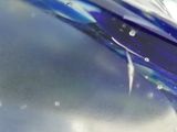 a close up of a blue glass object in the water
