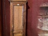 a tall wooden grandfather clock in the corner of a room