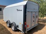 a trailer that is parked in the grass