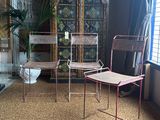 two chairs and a table in a room next to a window