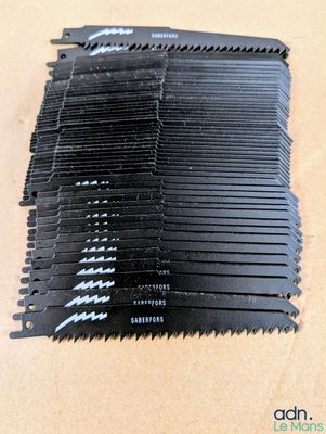 black plastic combs are stacked on top of each other on a table