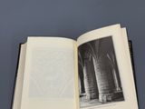 un livre ouvert posé sur une table, avec une image représentant des colonnes