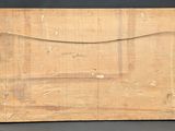 an old piece of wood with a string around it and a piece of paper on top of it