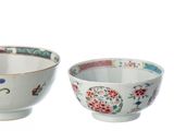three bowls and a cup sitting next to each other