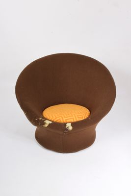 une chaise marron avec un coussin jaune dessus