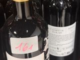 several bottles of wine are lined up on a shelf in a store