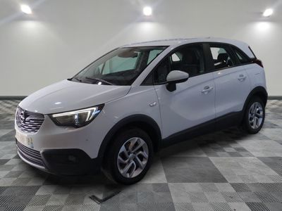 the white opel is parked in a large room with a checkered floor