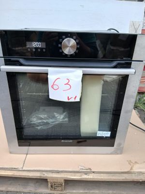 a black and silver oven with a price tag on it