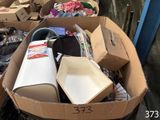 a cardboard box filled with assorted items in the street