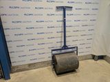 a roll of paper sitting on the floor in front of a wall