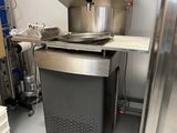 a machine that is sitting in a room next to a shelf