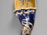 a picture of a blue and yellow spoon with a picture of a woman on it