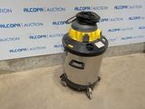the vacuum is sitting on the floor in front of the wall