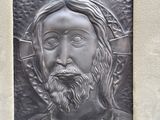 a picture of a metal plaque of jesus on a wall