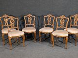 four chairs with upholstered backs and a beige upholstered seat