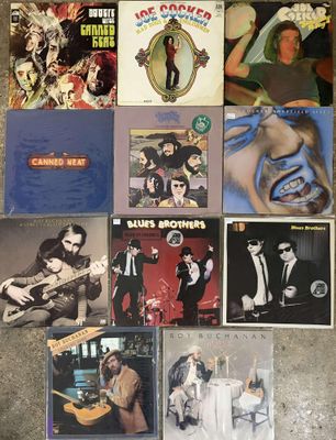 several albums of various music are laying on the floor