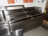 a stainless steel sink in the middle of a kitchen