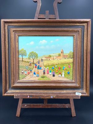 une peinture représentant une peinture montrant des personnes dans un champ, posée sur un chevalet