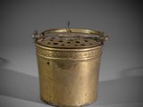 an old brass pot with a lid and a handle