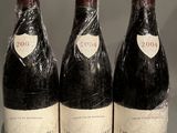 three bottles of wine sitting on top of a table next to each other