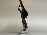 statue of a woman holding a bird on a marble base