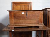 a wooden chest sitting on top of a wooden table