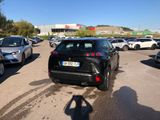many cars parked in a parking lot with a person taking a picture