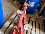 a red fire hydrant sitting on a pallet in a garage