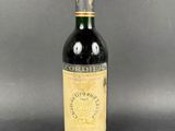 a bottle of red wine sitting on top of a table