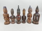 seven wooden figurines of different shapes and sizes