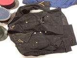 a black jacket, hat, and other items on a table