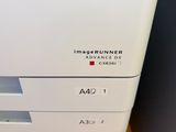 an imagerunner advance dx printer sitting on top of a desk