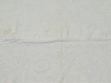 a close up of a white towel on a bed