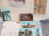 many postcards and postcards on a table