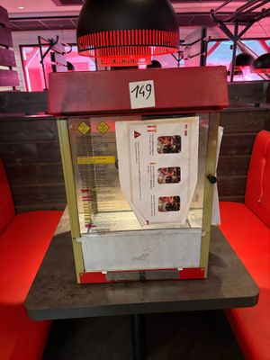 a popcorn machine sitting on a table in a restaurant