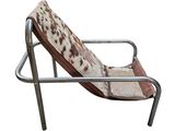 a chair with a cow print seat and a metal frame
