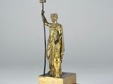 bronze statue of a woman holding a bird on a marble base