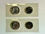 three different types of coins are displayed on a white surface