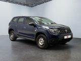 the dark blue dacia is parked in a large room