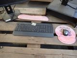 a keyboard, mouse, mouse pad and a mouse pad on a wooden pallet