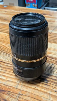 a close up of a camera lens on a wooden table