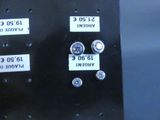 a close up of a metal panel with buttons and numbers on it