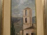 une photo d'un tableau représentant une église, dans un cadre doré